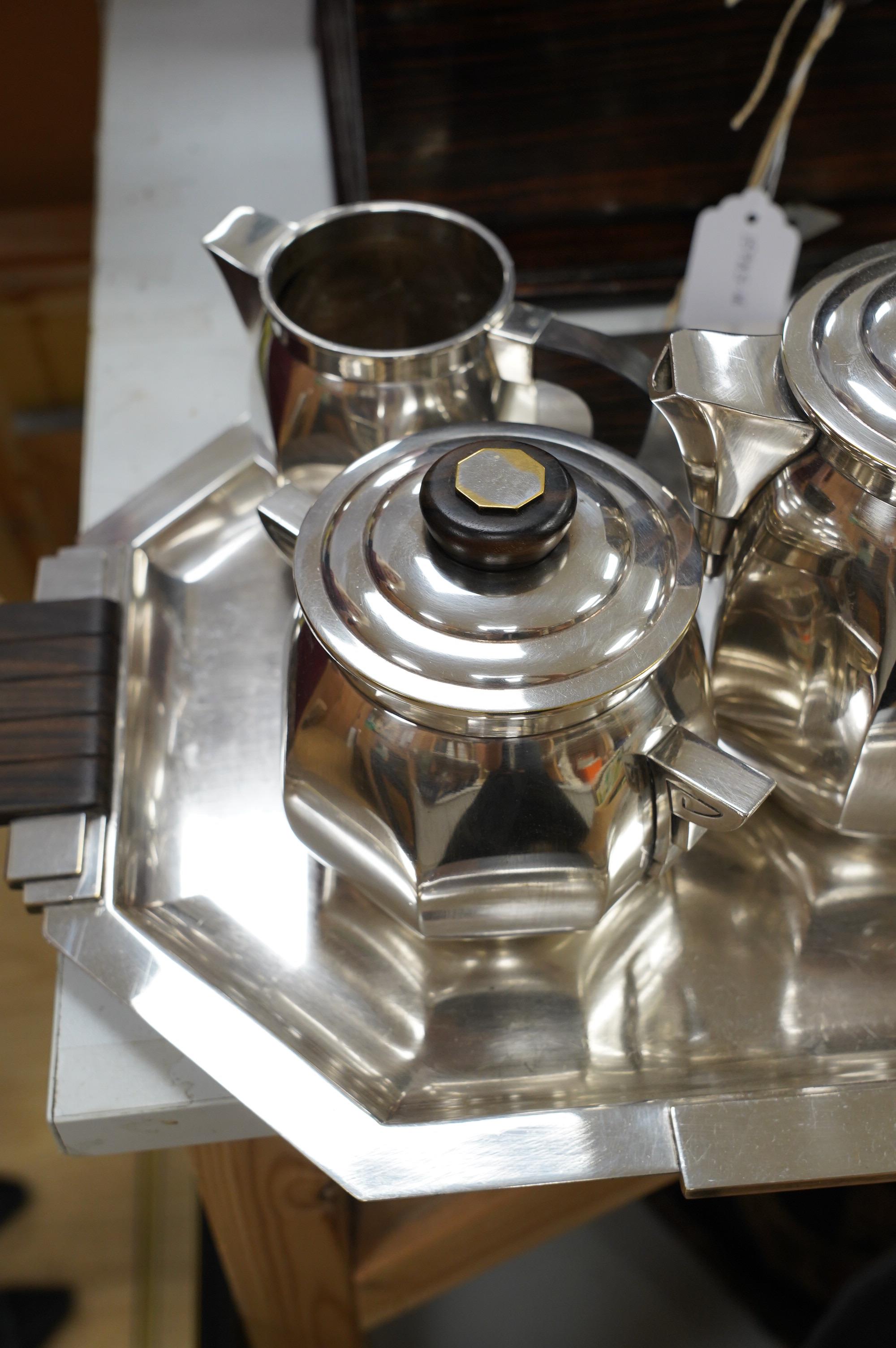 An Art Deco silver plated tea service, comprising tray, milk jug, sugar bowl, tea pot and coffee pot, tray 51cm wide. Condition - good